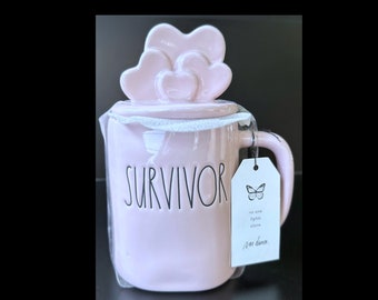 Rae Dunn "SURVIVOR" Pink Ceramic Coffee Mug With The Hearts on a Pink Ceramic Topper Option To Add Swarovski Crystal