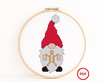 Gnome wearing a Santa Hat holding a Gingerbread Man Cross Stitch Pattern