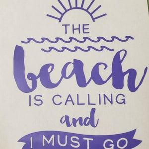 May include: A white background with purple text that reads "THE BEACH IS CALLING and I MUST GO." The design includes a sun, waves, and a banner. This image is perfect for beach lovers.