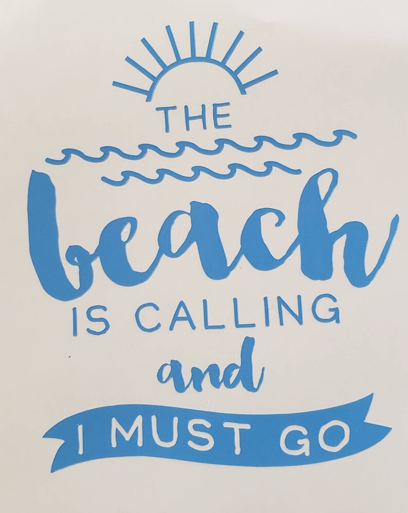 May include: A white background with blue text that reads "THE BEACH IS CALLING and I MUST GO." The design includes a sun, waves, and a banner. The text is in a handwritten style.