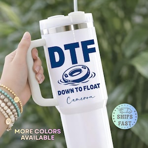 May include: White insulated tumbler with a handle, featuring the navy blue text "DTF" above a graphic of a pool float, and the words "DOWN TO FLOAT" and a name. The tumbler has a white lid and handle.
