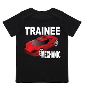May include: Black t-shirt with white text that reads "Trainee Mechanic" and a red cartoon sports car.