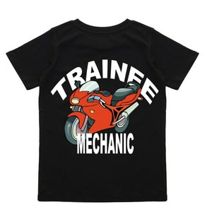 May include: Black t-shirt with a white graphic of a red motorbike and the text "TRAINEE MECHANIC".