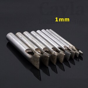 May include: A set of eight metal leather hole punches with different sizes. The punches are arranged in order of size, with the smallest punch on the left and the largest punch on the right. The punches are all made of metal and have a silver finish. The largest punch is labeled "1 mm".