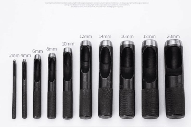 May include: Set of 10 black metal hole punch tools with different sizes ranging from 2mm to 20mm. The tools have a silver-colored metal tip and a black rubber handle.