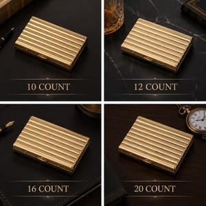 May include: Four gold-colored, rectangular cases with a ribbed design are displayed. Each case is labeled with a count: 10, 12, 16, and 20. The cases are on a dark surface, with a pen, a glass, and a pocket watch visible.