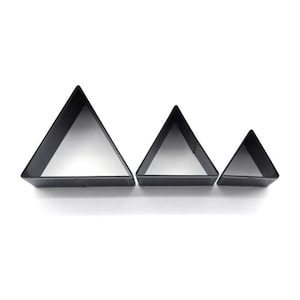 May include: Set of three black metal triangle cookie cutters in different sizes.
