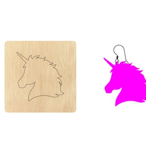 May include: A wooden cutout of a unicorn head, with a pink unicorn head earring next to it.