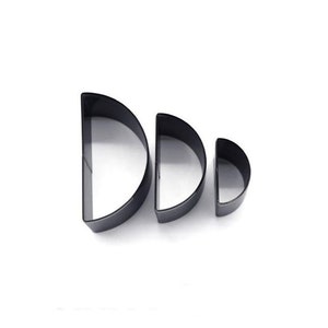 May include: Set of three black metal half-circle cookie cutters.