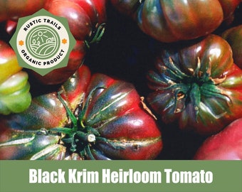 May include: Close-up of dark red and green heirloom tomatoes with a green stem. The tomatoes have a wrinkled, bumpy texture. A green and white sticker reads "Rustic Trails Organic Product".