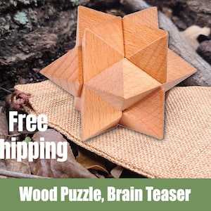 May include: A wooden star-shaped puzzle, a brain teaser, on a burlap bag with the text "Free Shipping" in white letters.  Wood Puzzle, Brain Teaser.