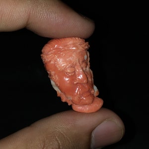 Natural CORAL/Hand carved FACE/Width 18MM/Length 30MM/Height 7MM/Weight 21.90 carats/Beautiful deep orange color/Face carving/Fancy carving