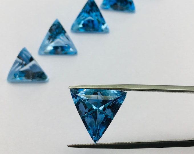Blue topaz cut stone/ triangle shape/ width 15.00mm/ length 15.00mm/ height 10.00mm/ piece 1/ weight 11.87 carat/ price 105.00 usa dollar