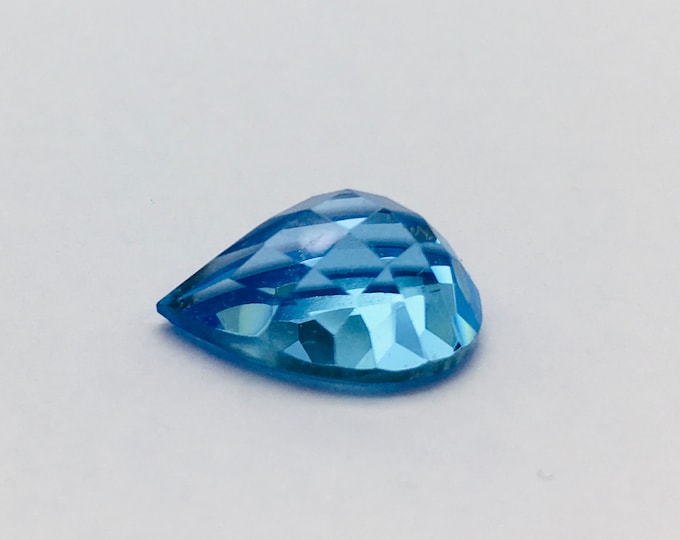 Swiss blue topaz cabochon/ chaker cut on top/ pear shape/ width 10.00mm/ length 15.00mm/ height 7.00mm/ wt 8.15 carat/ 173.00 usa dollar