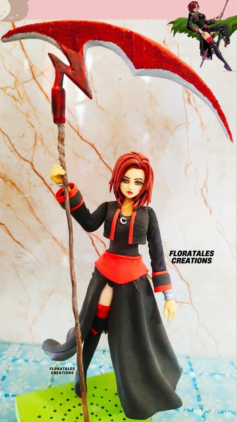 May include: A handcrafted figurine of a character holding a red scythe. The figure wears a black outfit with red accents and has red hair. The text "FLORATALES CREATIONS" is visible.