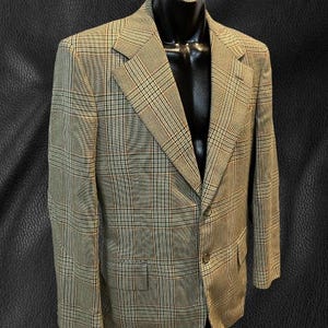 May include: A brown, beige, and black plaid blazer with a single button closure.