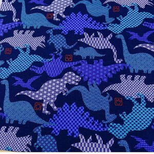 May include: Blue fabric with a repeating pattern of dinosaurs in various poses. The dinosaurs are outlined in white and filled with different blue and white geometric patterns.