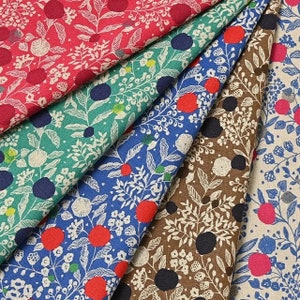 May include: A collection of five fabric swatches with different floral and polka dot patterns. The fabrics are in shades of blue, green, brown, and red.