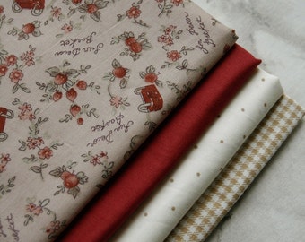 May include: A stack of four fabric swatches in various patterns and colours. The top swatch is beige with a floral pattern and the text "Sun Decor Basket". The second swatch is a solid red, the third is white with small brown dots, and the bottom swatch is a brown and white checked pattern.