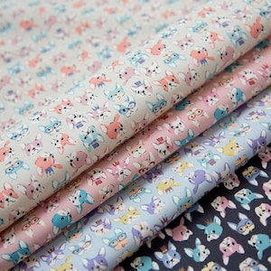 May include: A stack of patterned fabric rolls featuring a repeating design of cartoon dog faces in various colors. The fabric has a light background with dogs in pink, blue, and orange. The fabric is suitable for sewing and crafting projects.