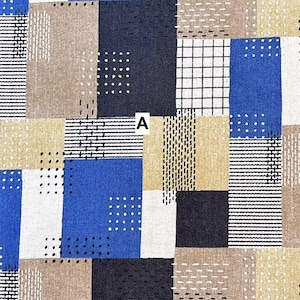 May include: A fabric swatch featuring a geometric pattern of rectangular blocks in shades of blue, black, beige, and white. The blocks are decorated with various black and white line work, including grids, dots, and dashes. The letter A is centered.