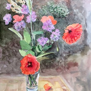May include: Watercolour painting of a floral still life. A clear glass holds a bouquet of red poppies, purple flowers, and green foliage. A single petal rests on the table. The background is a dark, textured wash.