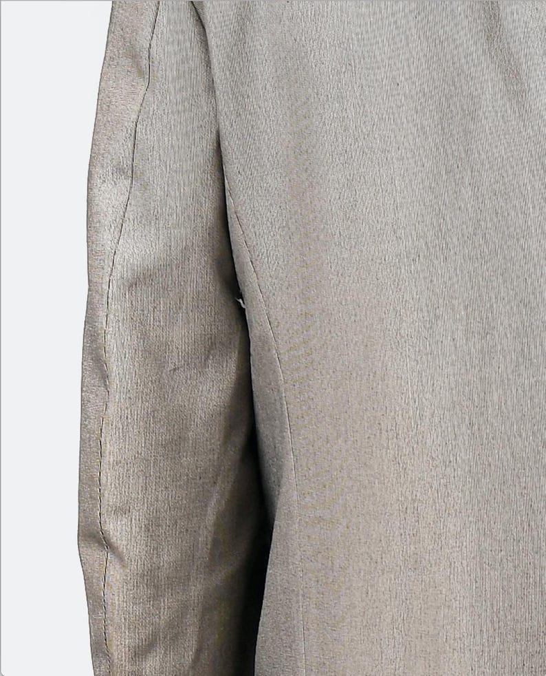 May include: A close-up of the sleeve of a gray blazer. The fabric has a subtle texture and a single seam down the side.