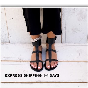 May include: Black leather gladiator sandals with ankle straps. The sandals have a toe thong and a buckle closure.  EXPRESS SHIPPING 1-4 DAYS