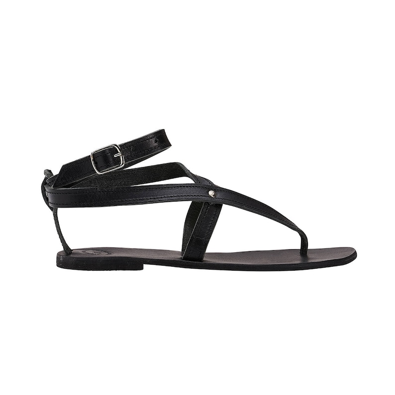 May include: Black leather sandals with a buckle strap and a simple design.