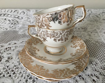 Pair of Ashley English bone china teacup trios with 22 kt gold decoration