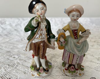 Pair of Sitzendorf figures of boy and girl in 18th century dress