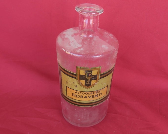 Bouteille ancienne de pharmacie,verre transparent soufflé-moulé avec son étiquette Alcoolat de Fioraventi,