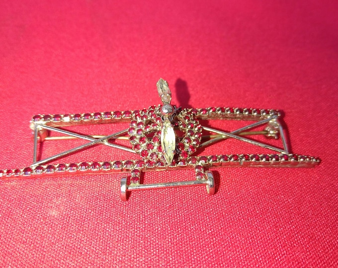 broche ancienne en forme d'avion à hélice, strass grenat et blanc