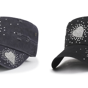 May include: Two black and dark blue military style caps with a heart design made of rhinestones.
