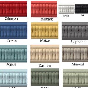 May include: A chart of 12 paint colors with names like Crimson, Rhubarb, Ocean, Maize, Elephant, Agave, Cashew, Mineral, Pool, Moss, and Celery. Each color is shown on a textured molding.
