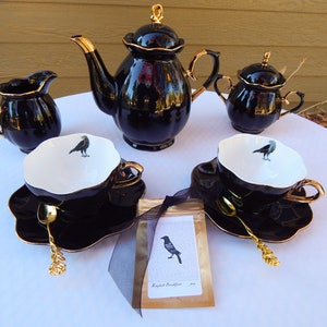 Edgar Allan Poe  The Raven Tea Set  Black Gold Porcelain Teapot  sugar bowl, creamer, two Crow teacups, gold plated spoons, tea packet,