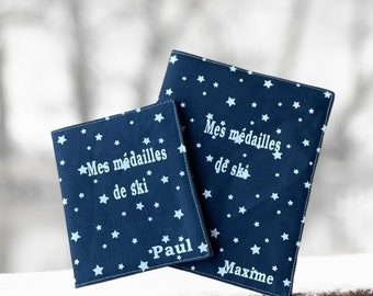 Navy blue ski medal pouch with white stars.