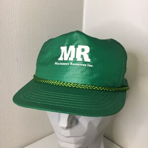 May include: A green baseball cap with a white rope trim and the logo "MR Machinery Resources Inc."