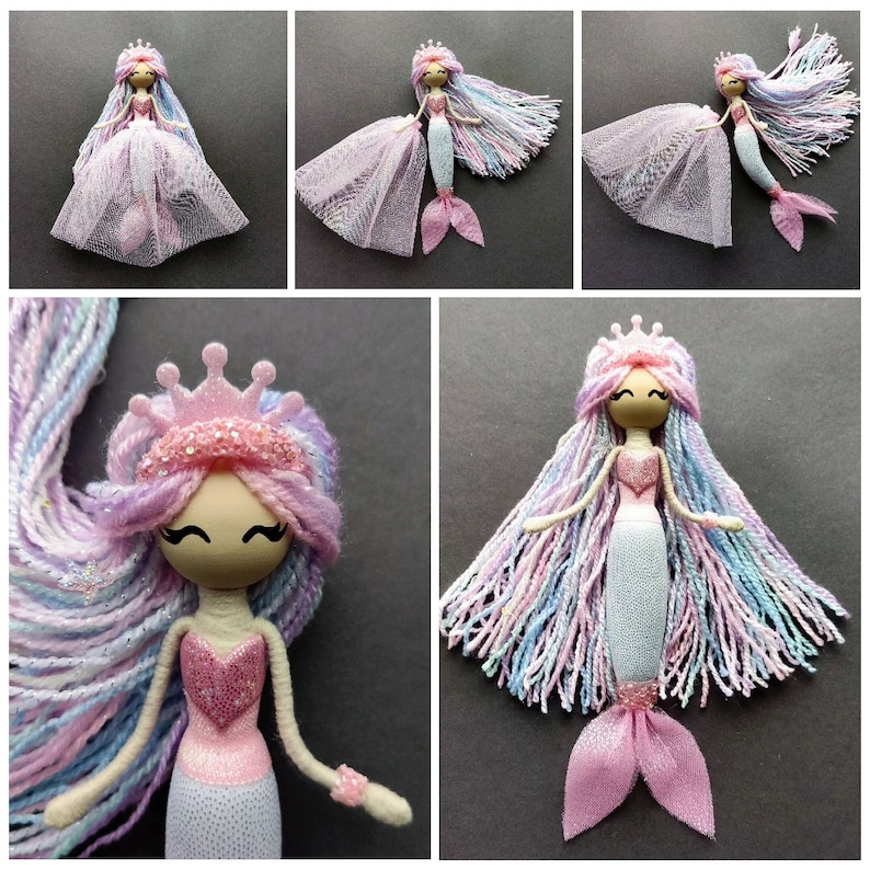 May include: A handmade mermaid doll with a pink crown, pink and white glitter fabric, and long, colorful yarn hair. The doll is wearing a pink and white glitter fabric dress and has a pink tail.