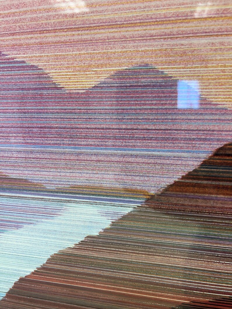 May include: Abstract artwork featuring layered horizontal lines in shades of brown, purple, and blue. The composition suggests a landscape with mountain-like shapes and a light blue area, creating a textured, artistic effect.