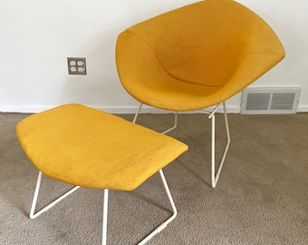 May include: A yellow chair and ottoman with a white wire frame. The chair and ottoman are made of a textured fabric.
