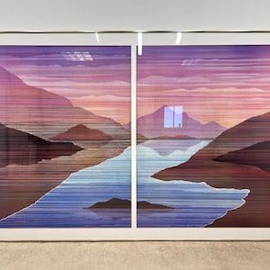 May include: Large framed artwork depicting a landscape with mountains, a river, and a sunset. The artwork is divided into two panels and features a color palette of purples, pinks, blues, and browns. The frame is gold-colored.