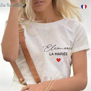 May include: White t-shirt with the text "Eleonore LA MARI&Eacute;E" and a red heart.