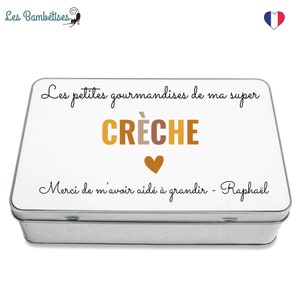 May include: A rectangular metal tin with a white lid featuring the text "Les petites gourmandises de ma super CR&Egrave;CHE" in black and gold lettering, with a gold heart and the text "Merci de m'avoir aid&eacute; &agrave; grandir - Rapha&euml;l".