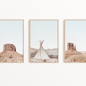 May include: A set of three framed prints featuring desert landscapes with red rock formations and a teepee in the middle print.