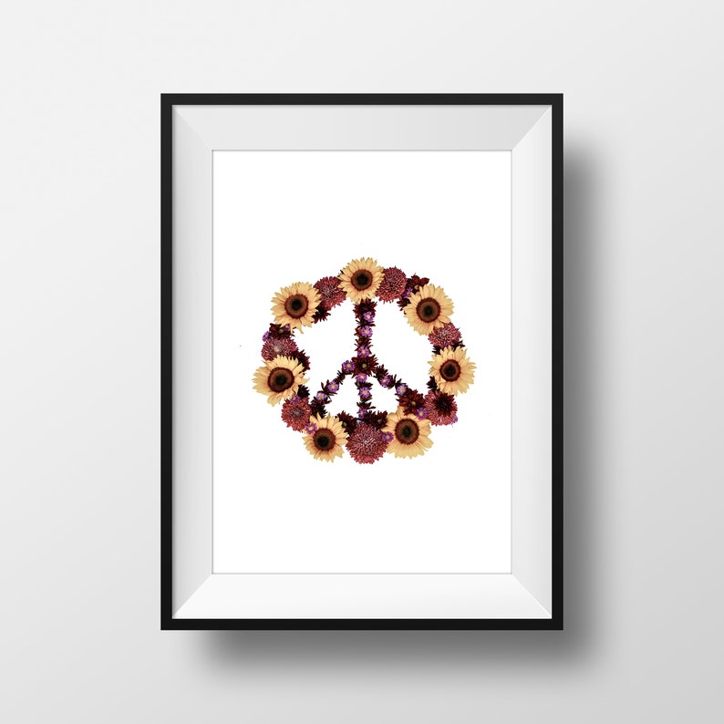 May include: A framed print of a peace sign made of flowers. The peace sign is made of yellow sunflowers and purple and red flowers.