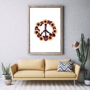 May include: A framed print of a peace sign made of sunflowers and purple flowers on a white background.