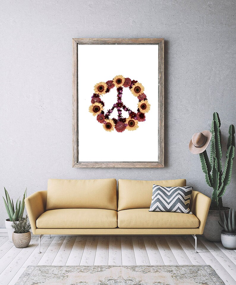 May include: A framed print of a peace sign made of sunflowers and purple flowers on a white background.