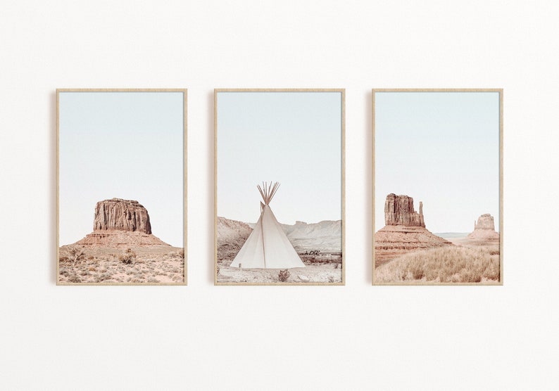 May include: A set of three framed prints featuring desert landscapes with red rock formations and a teepee in the middle print.