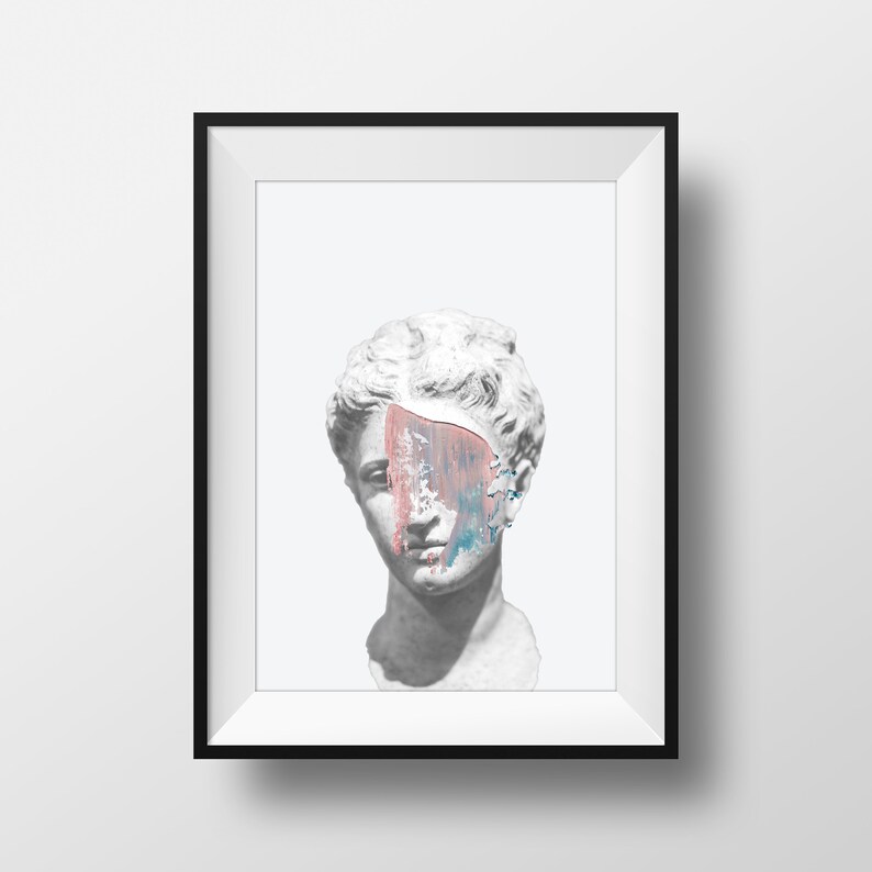 May include: A white plaster bust of a woman with a painted face. The paint is pink, blue, and white and covers part of the face. The bust is framed in a black frame.